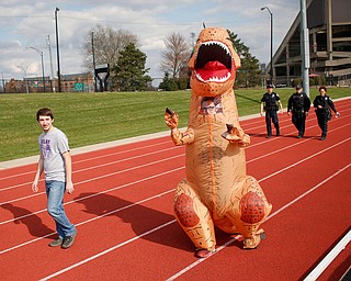 Lucas Swerdan, left, a sophomore studying electrical engineering at YSU, and Zack Digman, a junior studying forensic science, walk around the track at Farmers National Bank Field during YSU Relay for Life Saturday afternoon. EMILY MATTHEWS | THE VINDICATOR