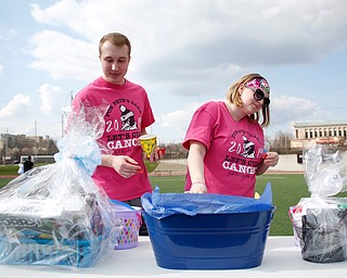 YSU students Jordan Zackasee, left, a senior studying chemistry, and Maddie Sanders, a senior studying early childhood education and special education, look at raffle baskets at Farmers National Bank Field during YSU Relay for Life Saturday afternoon. EMILY MATTHEWS | THE VINDICATOR