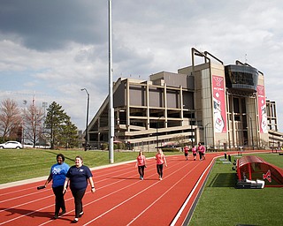 People walk around the track at Farmers National Bank Field during YSU Relay for Life Saturday afternoon. EMILY MATTHEWS | THE VINDICATOR