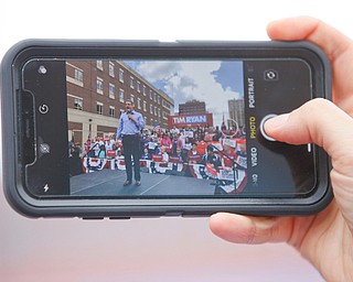 A member of the crowd takes a photo of Tim Ryan during his presidential kickoff rally on Federal Street Saturday afternoon. EMILY MATTHEWS | THE VINDICATOR