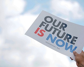 A member of the crowd holds up a sign during Tim Ryan's presidential kickoff rally on Federal Street Saturday afternoon. EMILY MATTHEWS | THE VINDICATOR