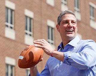 Tim Ryan prepares to throw a football into the crowd during his presidential kickoff rally on Federal Street Saturday afternoon. EMILY MATTHEWS | THE VINDICATOR