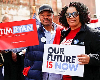 Ricky and Cheryl Findley, of Youngstown pose for a photo while holding Tim Ryan signs during Ryan's presidential kickoff rally on Federal Street Saturday afternoon. EMILY MATTHEWS | THE VINDICATOR