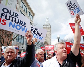 People hold up campaign signs during Tim Ryan's presidential kickoff rally on Federal Street Saturday afternoon. EMILY MATTHEWS | THE VINDICATOR