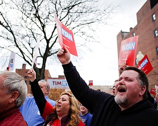 People hold up campaign signs during Tim Ryan's presidential kickoff rally on Federal Street Saturday afternoon. EMILY MATTHEWS | THE VINDICATOR