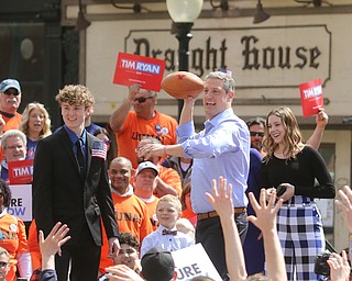  ROBERT K.YOSAY  | THE VINDICATOR..Congressman Tim Ryan  opened his run for president in Downtown Youngstown as supporters gathered and cheeered..Afterwards...  passing out YSU footballs - as Mason and Bella his children watch