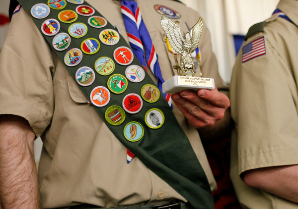 Eagle Scout Colin Russell, of troop 60, holds his award after being recognized with other Eagle Scouts at the Whispering Pines Recognition Dinner in St. James Episcopal Church in Boardman on Sunday. EMILY MATTHEWS | THE VINDICATOR