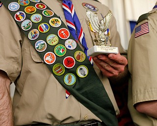 Eagle Scout Colin Russell, of troop 60, holds his award after being recognized with other Eagle Scouts at the Whispering Pines Recognition Dinner in St. James Episcopal Church in Boardman on Sunday. EMILY MATTHEWS | THE VINDICATOR