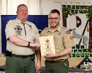 John Brkic, right, District Director, presents Jason Henry, of pack 25 in Canfield, with the Cubmaster of the Year award at the Whispering Pines Recognition Dinner in St. James Episcopal Church in Boardman on Sunday. EMILY MATTHEWS | THE VINDICATOR