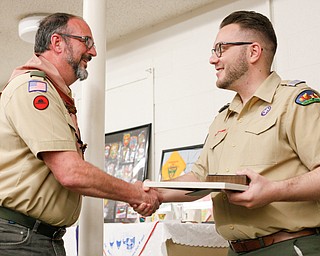 Albin Dearing, left, shakes hands with District Director John Brkic as he's presented with the District Award of Merit at the Whispering Pines Recognition Dinner in St. James Episcopal Church in Boardman on Sunday. EMILY MATTHEWS | THE VINDICATOR