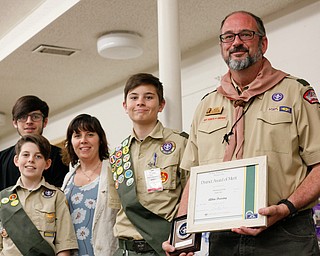 Albin Dearing, right, holds his District Award of Merit as he stands with his family Albin Dearing, 17, Gabriel Dearing, 12, his wife Kathleen Dearing, and Noah Dearing at the Whispering Pines Recognition Dinner in St. James Episcopal Church in Boardman on Sunday. EMILY MATTHEWS | THE VINDICATOR