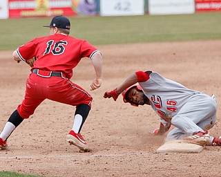 UIC's Derrick Patrick slides into third while YSU's Blaze Glenn waits for the ball to come in from left field during their game on Sunday afternoon. YSU lost 8-3.