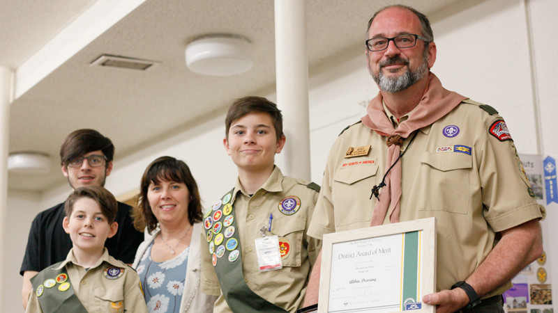 Albin Dearing, right, holds his District Award of Merit as he stands with his family, left to right, Albin Dearing, 17; Gabriel Dearing, 12; his wife, Kathleen Dearing, and Noah Dearing at the BSA’s Whispering Pines District recognition dinner Sunday in St. James Episcopal Church in Boardman.