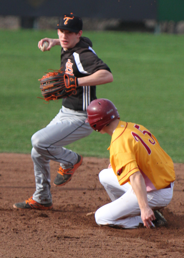 William D. Lewis The Vindicator Mooney's Walter Sweeney(15) is out a 2nd as Springfield's Nick Slike(2) looks to throw to frist.