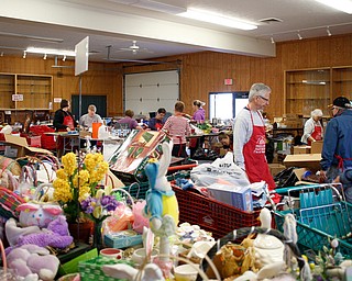 Volunteers get the main room ready for the Angels for Animals garage sale in building 24 at the Canfield Fairgrounds on Tuesday morning. The garage sale will take place Friday through Sunday at the fairgrounds. EMILY MATTHEWS | THE VINDICATOR