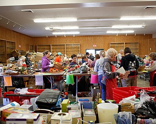 Volunteers get the main room ready for the Angels for Animals garage sale in building 24 at the Canfield Fairgrounds on Tuesday morning. The garage sale will take place Friday through Sunday at the fairgrounds. EMILY MATTHEWS | THE VINDICATOR