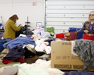 Volunteers Ruth Nabb, right, and Cheryl Pinten, both of Boardman, organize clothes that will be for sale at the Angels for Animals garage sale at the Canfield Fairgrounds on Tuesday morning. The garage sale will take place Friday through Sunday at the fairgrounds. EMILY MATTHEWS | THE VINDICATOR