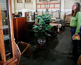 Diane Less, director of Angels for Animals, stands among furniture that will be for sale at the Angels for Animals garage sale at the Canfield Fairgrounds on Tuesday morning. The garage sale will take place Friday through Sunday at the fairgrounds. EMILY MATTHEWS | THE VINDICATOR