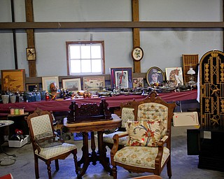 Many antique items, including paintings, figurines, and furniture, will be for sale in the antique room at the Angels for Animals garage sale that will be taking place Friday through Sunday at the Canfield Fairgrounds. EMILY MATTHEWS | THE VINDICATOR