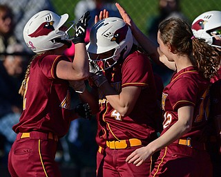 YOUNGSTOWN, OHIO - APRIL 9, 2019: Mooney's Catie Perry, center, is congratulated by her tames Brooke Chandler, right, and Gia DiFabio, left, after hitting a solo home run in the fourth inning of Tuesday afternoons game at Youngstown State Softball Complex. DAVID DERMER | THE VINDICATOR