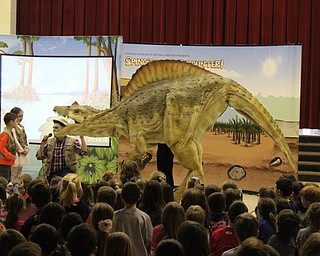 Neighbors | Abby Slanker.Two Hilltop Elementary School students got an upclose look at Spiny the Spinosaurus, especially her teeth, during the school’s Spinosaurus Encounter assembly on March 7.