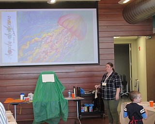 Neighbors | Jessica Harker.Librarian Assistant Amelia Dale taught children how to paint a jellyfish at the first Sip and Paint for children at the Michael Kusalaba library on March 12.