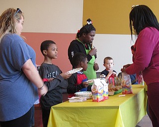 Neighbors | Jessica Harker.Children enjoyed snacks of goldfish, cookies and juice boxes at the first Sip and Paint for children at the Michael Kusalaba library.