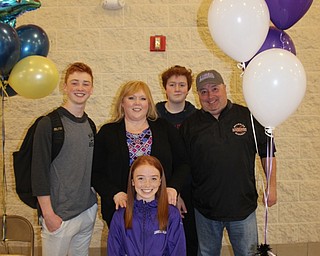 Neighbors | Abby Slanker.Canfield High School senior cross country and track athlete Julia Magliocca was surrounded by her family, from left, brother Dom, mom Beth, brother Nick and dad Ralph as she celebrated signing her letter of intent to continue her academic and cross country and track career at the University of Mount Union during a signing ceremony at the high school on March 15.