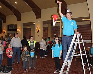 Neighbors | Abby Slanker.A Canfield Presbyterian Church Giant Egg Drop volunteer dopped a participant’s egg protection unit from a ladder on March 30.