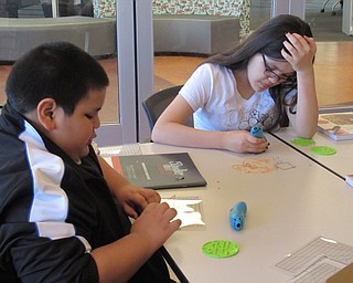 Neighbors | Jessica Harker.Israel Benardino and Valentino McKinley used 3D drawing pens to create different creations at the April 3 at the Michael Kusalaba library.