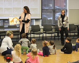 Neighbors | Abby Slanker.Youth librarian Megan Rankin (left) read “From Head to Toe” by Eric Carle during the Canfield library’s Gotta Move Story Time on March 13.