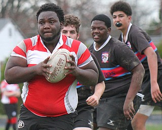 William D. Lewis The vindicator  Chaney's Shawn Rollins(5) eludes Canton defenders during 4-12-19 action at Chaney.