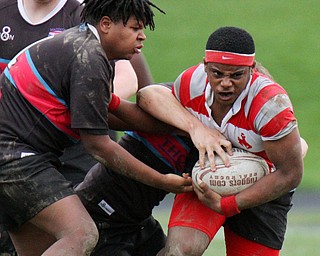 William D. Lewis The vindicator  Chaney's Tyler Sims(6) is stopped by a Canton defender during 4-12-19 action at Chaney.