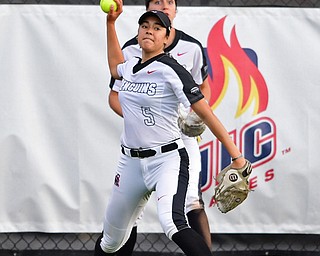 YOUNGSTOWN, OHIO - APRIL 12, 2019: Youngstown State's Yazmine Romero throws it in after a double by Cleveland State's Sydney Bajusz in the second inning of their game, Friday night at the Youngstown State softball complex. Youngstown State won 3-0. DAVID DERMER | THE VINDICATOR