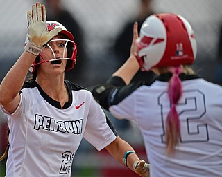 YOUNGSTOWN, OHIO - APRIL 12, 2019: Youngstown State's Lexi Zappitelli, left, is congratulated by Tatum Christy after scoring a run on a RBI-double by Grace Cea in the third inning of their game, Friday night against Cleveland State at the Youngstown State softball complex. Youngstown State won 3-0. DAVID DERMER | THE VINDICATOR