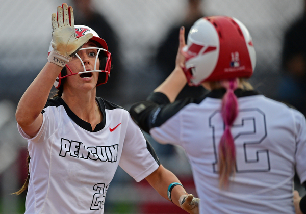 YOUNGSTOWN, OHIO - APRIL 12, 2019: Youngstown State's Lexi Zappitelli, left, is congratulated by Tatum Christy after scoring a run on a RBI-double by Grace Cea in the third inning of their game, Friday night against Cleveland State at the Youngstown State softball complex. Youngstown State won 3-0. DAVID DERMER | THE VINDICATOR