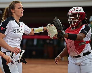 YOUNGSTOWN, OHIO - APRIL 12, 2019: Youngstown State starting pitcher Addy Jarvis, left, is congratulated by catcher Miyah Mitchum after the second inning of their game, Friday night against Cleveland State at the Youngstown State softball complex. Youngstown State won 3-0. DAVID DERMER | THE VINDICATOR
