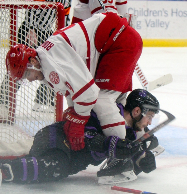 William D. Lewis The Vindicator Phantoms Daltn Messina(14) and ) moves the puck past Dubuque's Luke Robinson(9) get tangled up during 4-15-19 action in Youngstown.