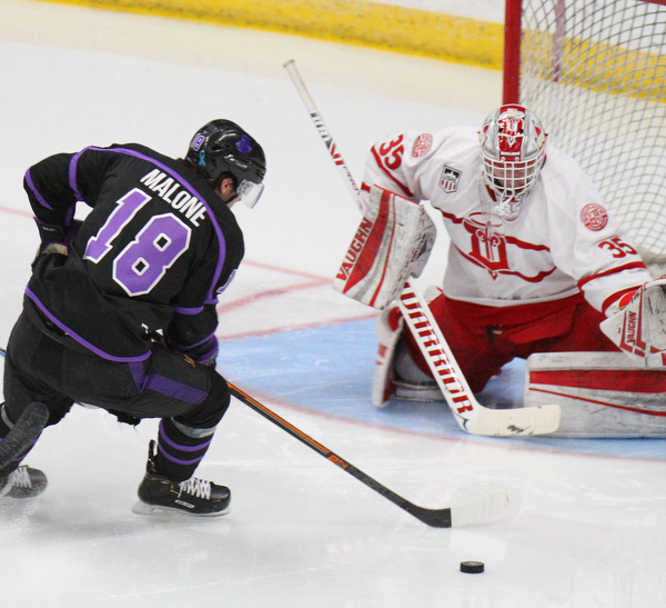 William D. Lewis The Vindicator Phantoms Jack Malone (18)lines up a shot  Dubuque's Matthew Thiessen (35) during 4-15-19 action in Youngstown.