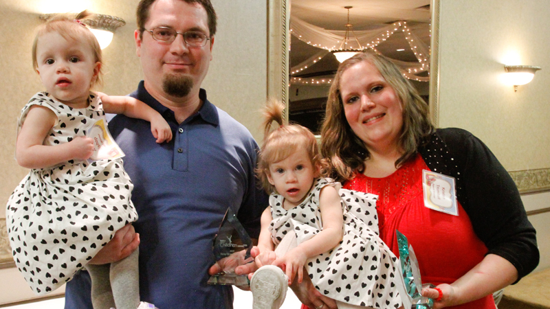 Kristen Trumbull, right, and her fiance, Justin Bishop, were granted temporary custody of 1-year-old twins Alicia and Tatiana through Trumbull County Children Services. Trumbull and Bishop were honored Tuesday for overcoming adversity to meet the needs of the children.