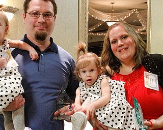 Kristen Trumbull, right, and her fiance, Justin Bishop, were granted temporary custody of 1-year-old twins Alicia and Tatiana through Trumbull County Children Services. Trumbull and Bishop were honored Tuesday for overcoming adversity to meet the needs of the children.