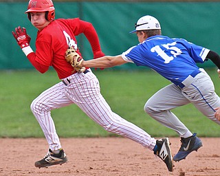 William D. Lewis The Vindicator Niles' Kenny Flanigan(4) is tagged in a run down between 2&3rd by Poland's Mason McCurdy(15) during 4-17-19 game.