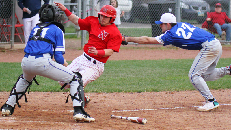 Nick Guarnieri (7) of Niles McKinley High School, is out at home during. Making the tag at Wednesday's game for Poland Seminary High School is Braden Olsen( 22). At the plate is Andrew Testa (11). Niles downed Poland, 4-1.