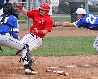 Nick Guarnieri (7) of Niles McKinley High School, is out at home during. Making the tag at Wednesday's game for Poland Seminary High School is Braden Olsen( 22). At the plate is Andrew Testa (11). Niles downed Poland, 4-1.