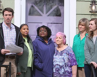 The Youngstown Neighborhood Development Corp. and its partners celebrate the organization’s 100th home rehabilitation on Rush Boulevard on the city’s South Side. Participating in Wednesday’s ceremony were, from left, Ian Beniston, YNDC executive director; Marguerite Douglas, YNDC board secretary; Dollaine Holmes, YNDC board vice president; Mary Danus, YNDC board treasurer; Debora Flora, executive director of the Mahoning County Land Bank; and Tiffany Sokol, YNDC housing director. 
