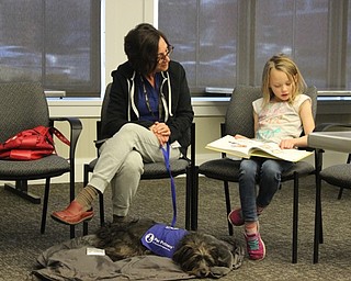 Neighbors | Abby Slanker.Sira, a three-and-a-half-year-old schnauzer and mutt mix and certified therapy dog with Pet Partners, listened to Emily Mihalick, of Canfield, read to her at the Canfield library’s Tales to Tails program on March 11, as Debora Macomber, Sira’s handler, listened in.
