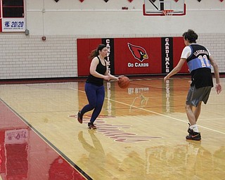Neighbors | Abby Slanker.Canfield High School staff member Carrie Miller dribbled down the court during the students versus staff basketball game, which National Honor Society members Luke Pallante and Svetha Nallapaneni organized as their service project on March 21.