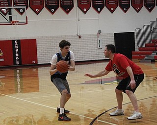 Neighbors | Abby Slanker.Canfield High School senior Aidan Burcsak was guarded closely by staff member Dan LaCivita  during the students versus staff basketball game, which National Honor Society members Luke Pallante and Svetha Nallapaneni organized as their service project on March 21.