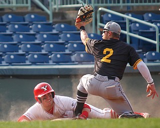 YSU's Lucas Nasonti gets called out at third after NKU's Andrew Bacon tags him out on a slide during their second game on Thursday. EMILY MATTHEWS | THE VINDICATOR