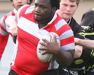 William D. Lewis The Vindicator Chaney's Shawn Rollins (23) eludes a Massilon defender during 4-18-19 action at Chaney.